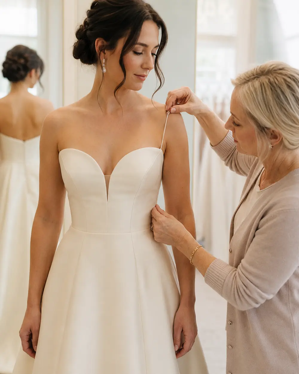 wedding-dress-bodice-neckline-fit Seamstress checking a wedding dress bodice and neckline