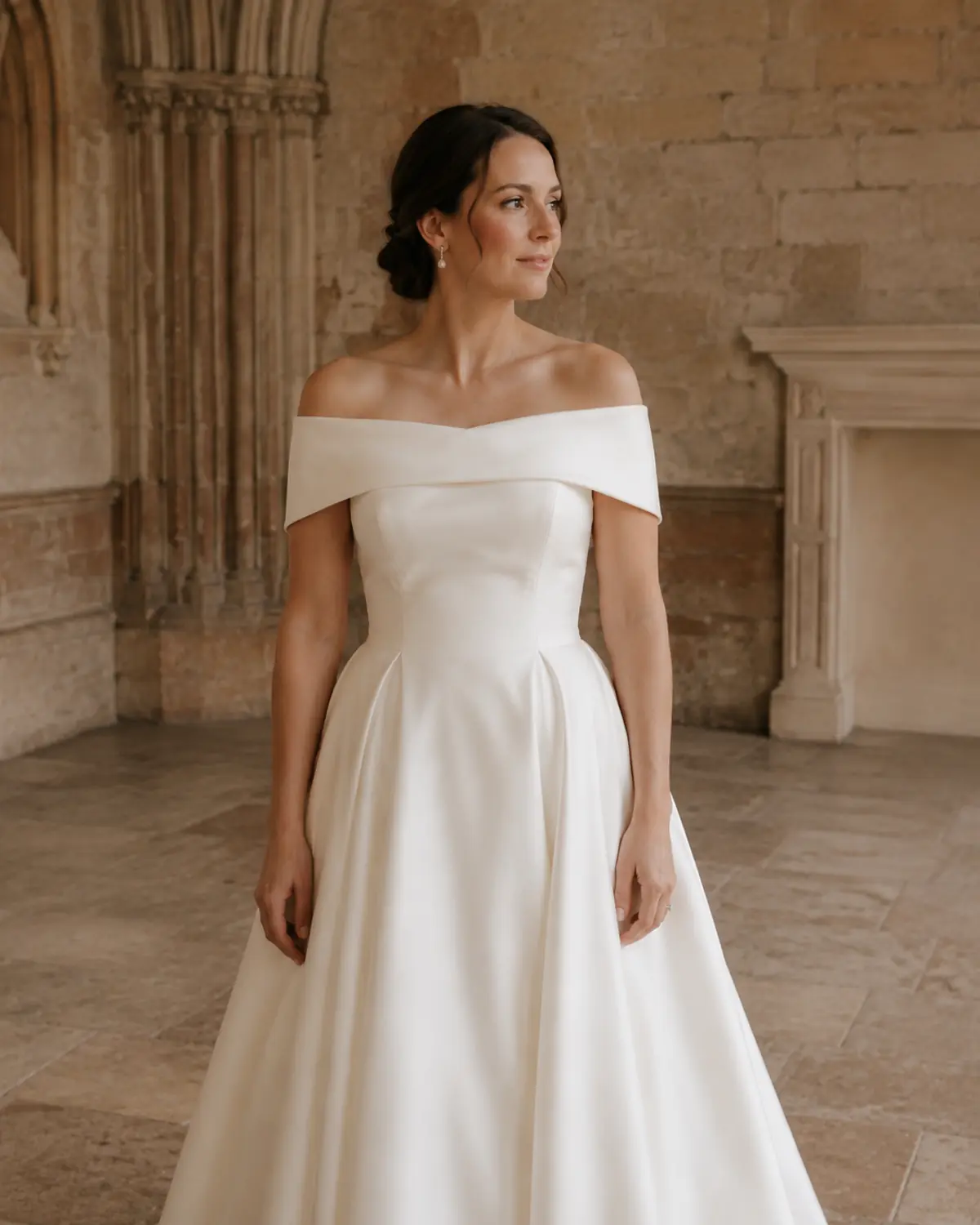 off-the-shoulder-wedding-dress-neckline Bride wearing a full-skirt wedding gown with an off-the-shoulder neckline